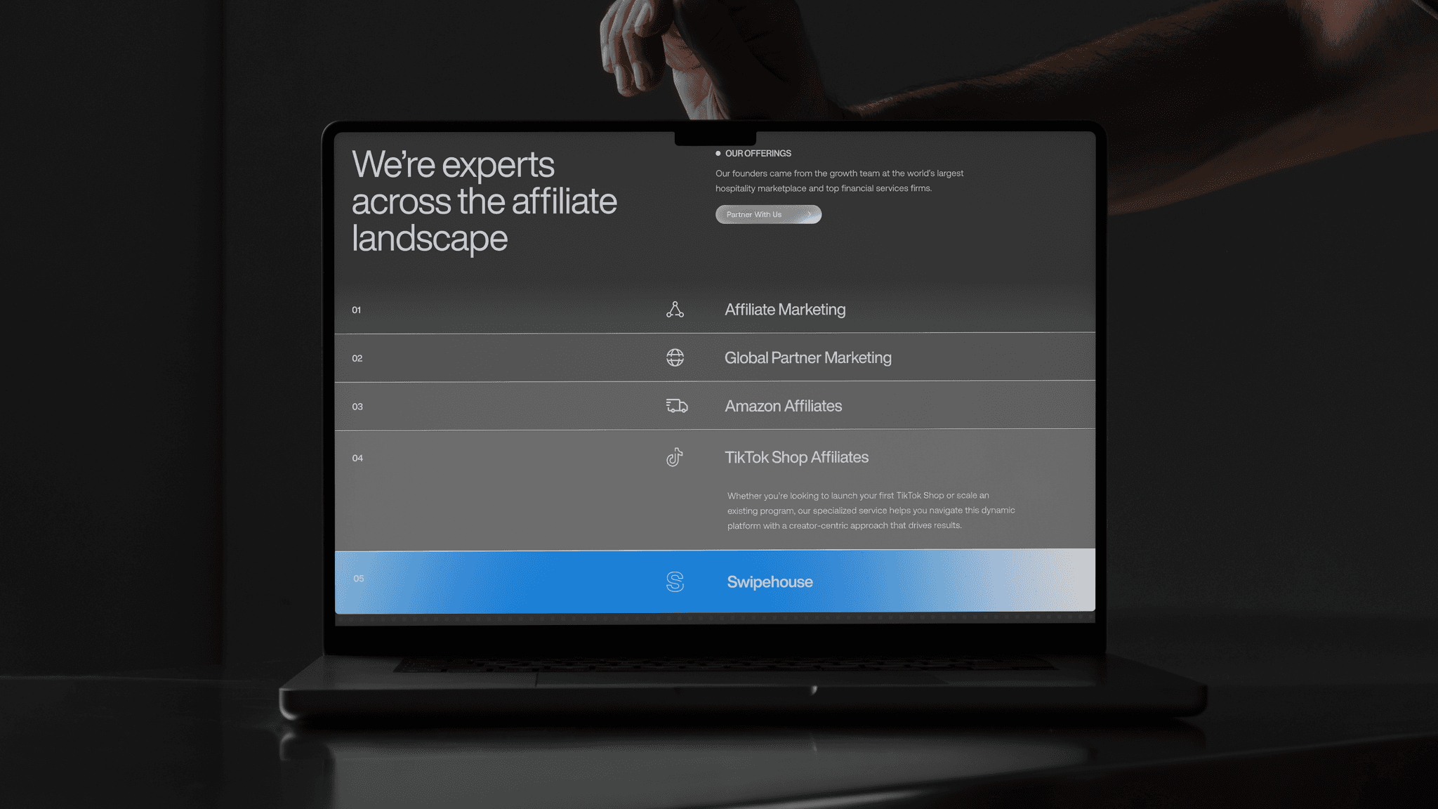 The Hamster Garage website on a laptop in the dark: "We're experts across the affiliate landscape"